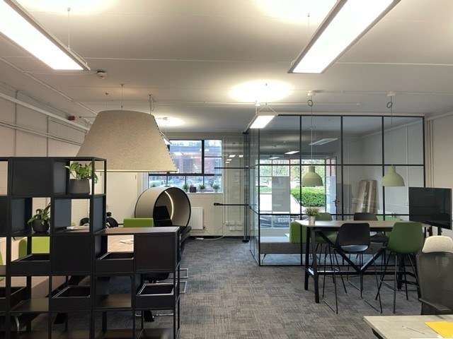 Open plan shot of planet office interior with desks, meeting pods and storage