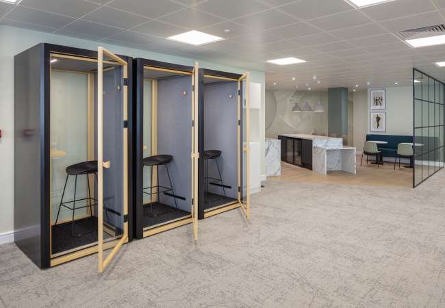 open plan with phone booths looking over to open kitchen tea point
