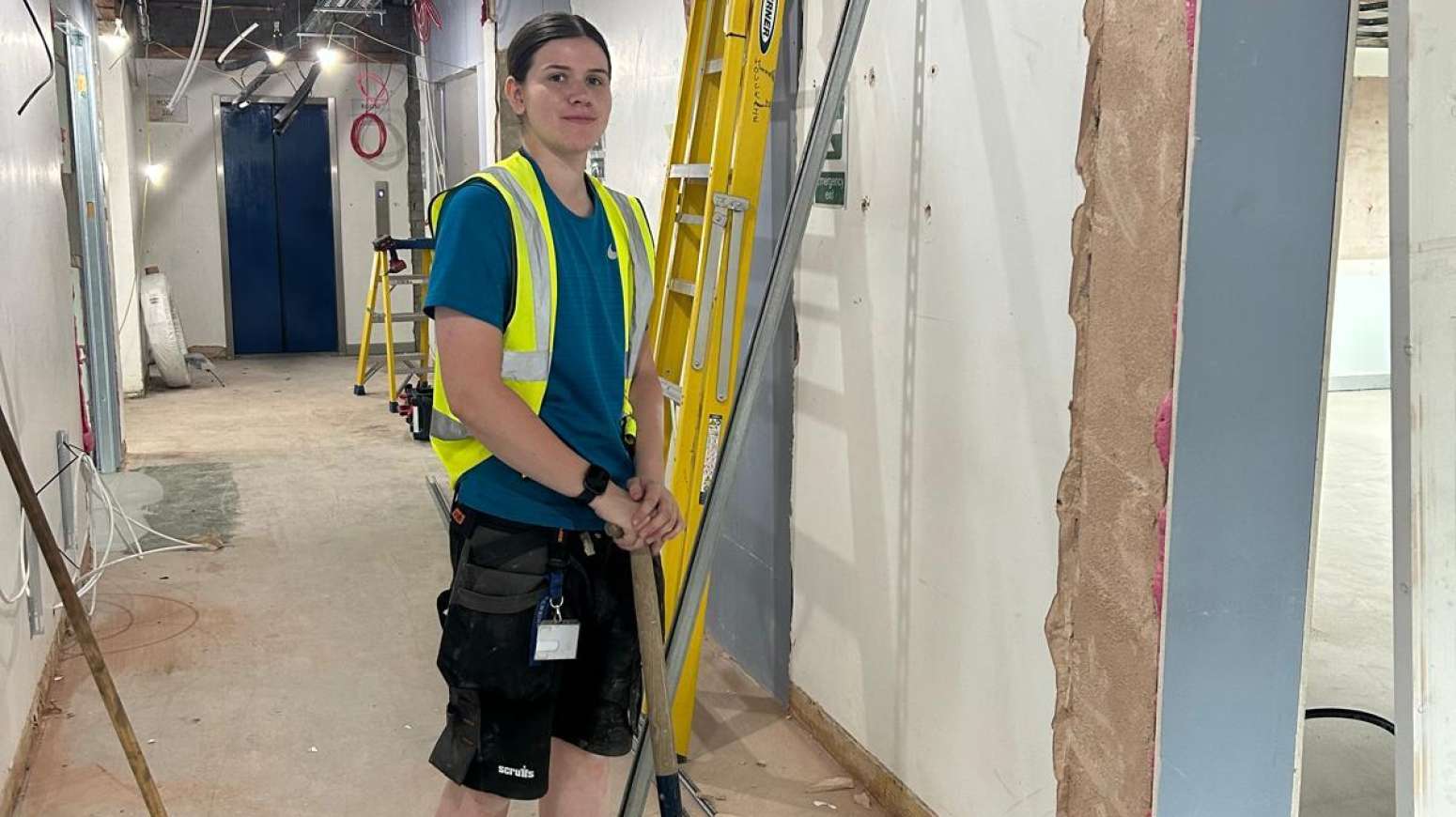 on site photo of Daisy on site at Tameside College working with site team on construction