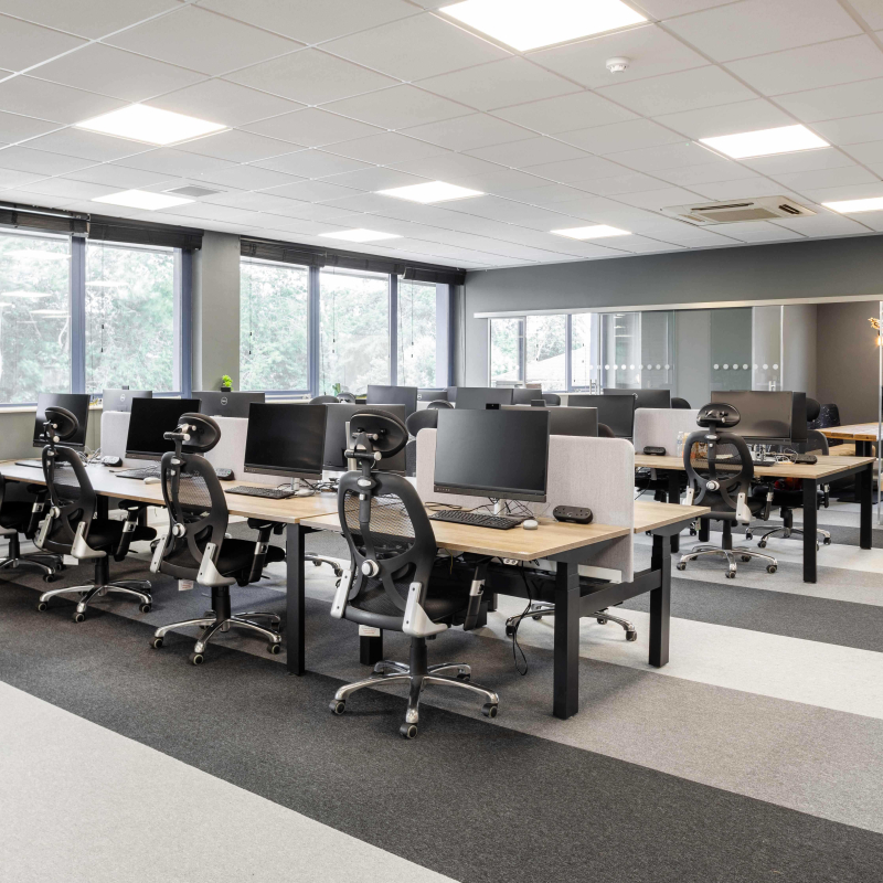 open plan office first floor with 2 banks of desks and height adjustable desks