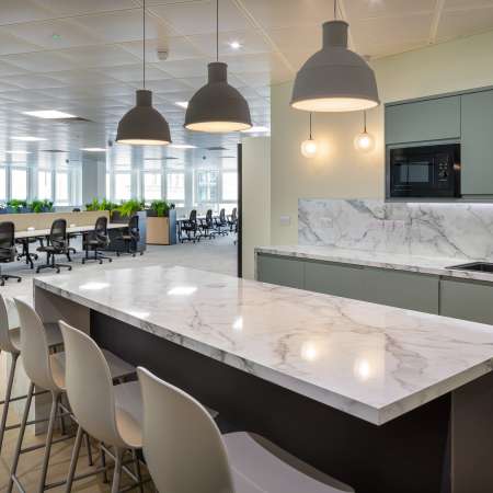 kitchen space looking out to open plan office with critall glass