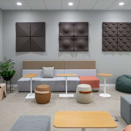 presentation and group meeting space with single seats, acoustic panels on the wall and AV